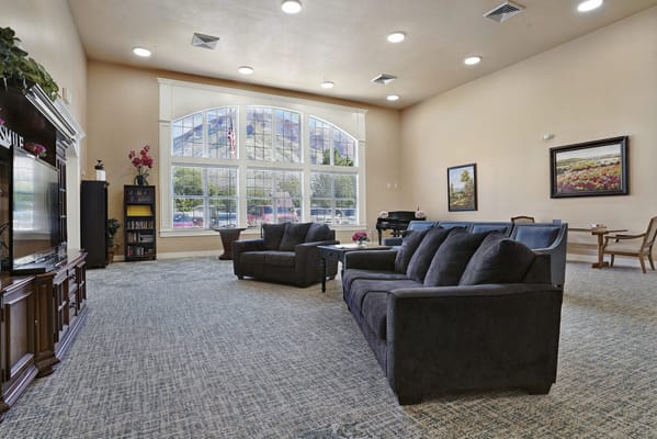 Bright common area with seating and large windows