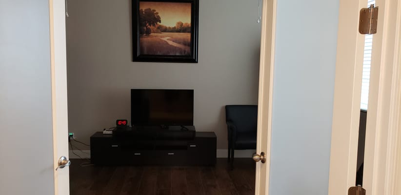 View into a private resident room with TV