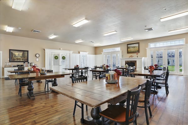 Interior view of a bright dining room with wooden tables