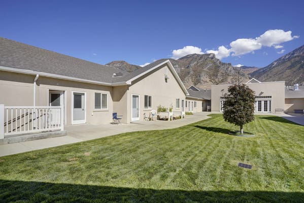 Exterior view of assisted living facility with mountains in background