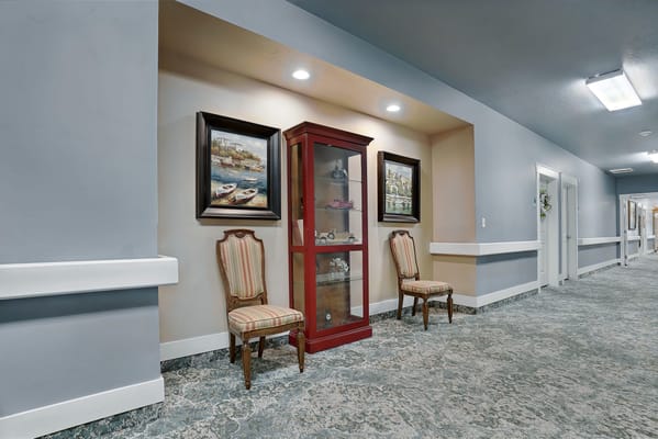 Interior view of a hallway with artwork and seating