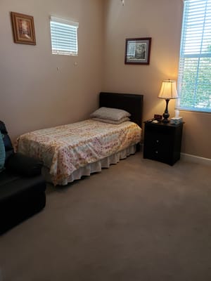 Cozy private room with a bed and lamp