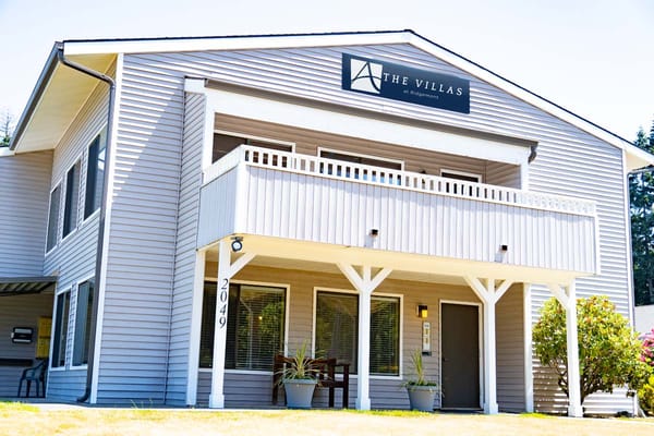 Exterior view of The Villas at Ridgemont with logo