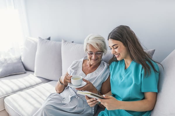 A caregiver and resident sharing a joyful moment indoors