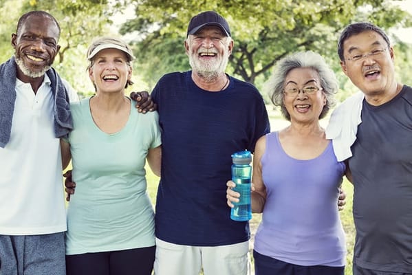 Group of smiling residents enjoying time outdoors