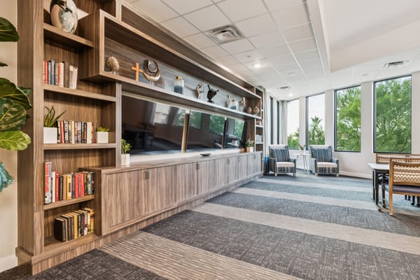 Bright common area with seating and bookshelves