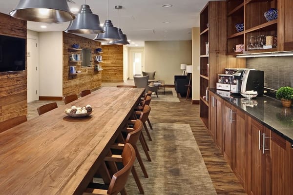 Common area with a large wooden table and seating