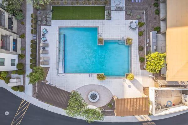 Aerial view of a swimming pool area with lounge chairs