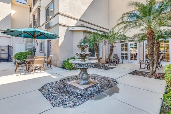 Outdoor courtyard with water fountain and seating
