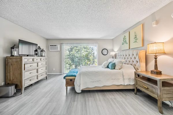 Bright interior of a resident room with a bed and window