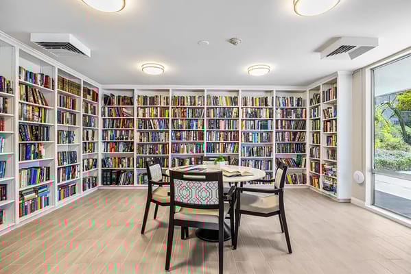 A cozy library with bookshelves and a table