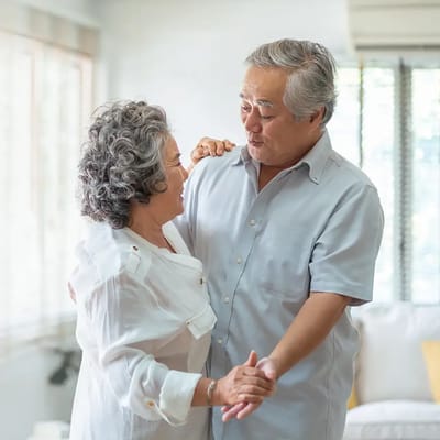 A couple dancing together in a cozy living room