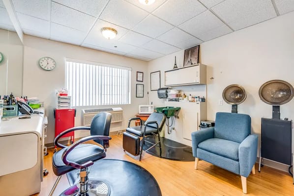 Interior view of a salon area with chairs and equipment
