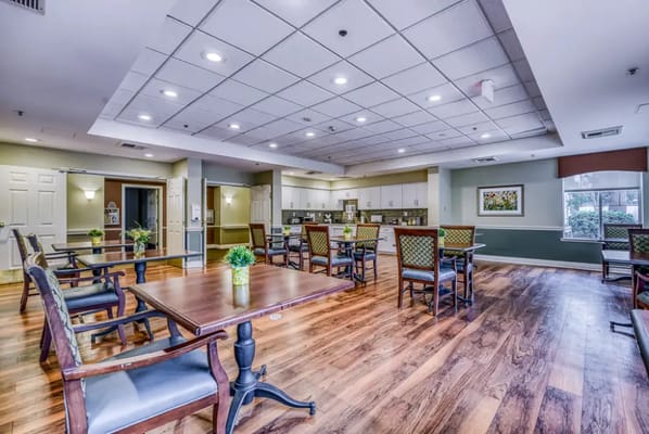 Common area with tables and chairs in a dining space