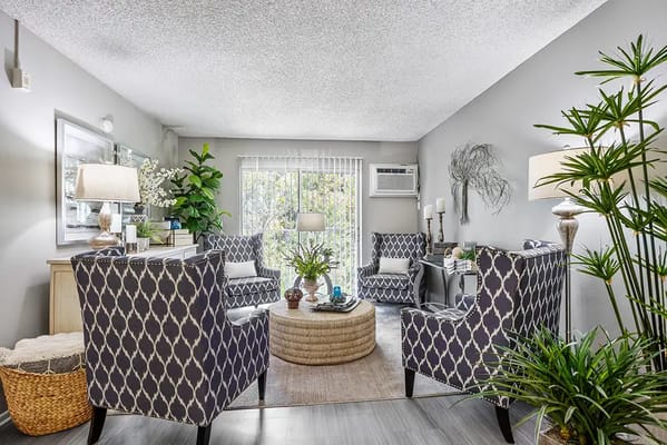 Bright common area with comfortable seating and plants