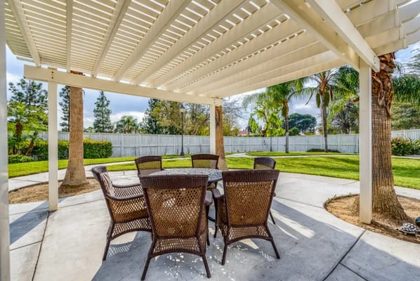 Outdoor seating area with tables and chairs in a garden