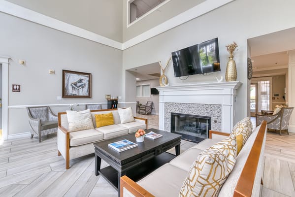 Bright common area with seating and a fireplace