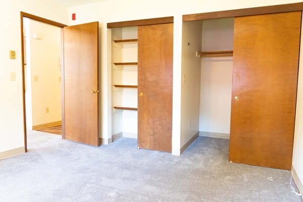 Interior view of a private resident room with open closet doors