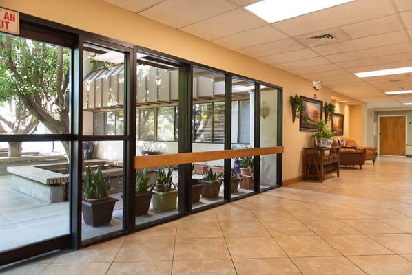 Interior hallway with plants and seating area