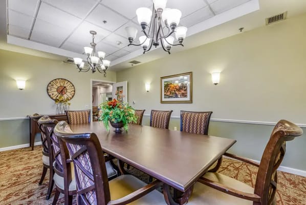 Interior dining area with a large table and chandelier