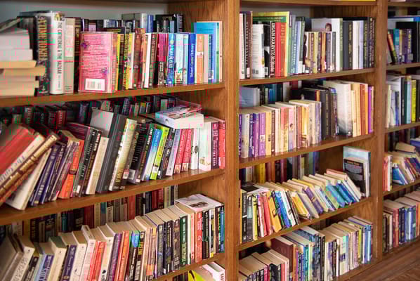 Bookshelves filled with various books in a library