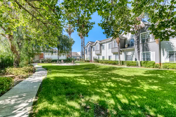 Landscaped outdoor area with walking path and seating
