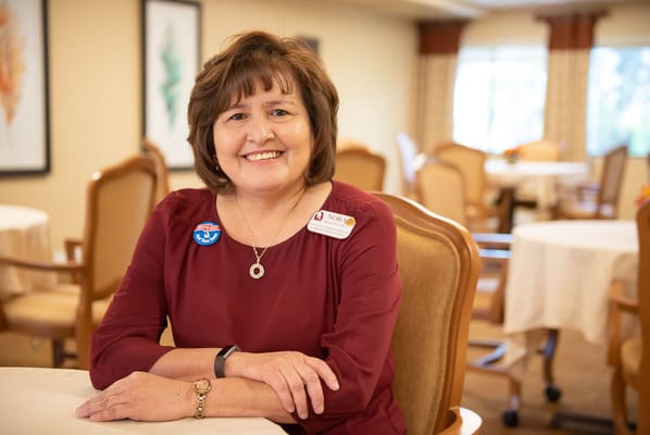 Staff member smiling in a bright common area