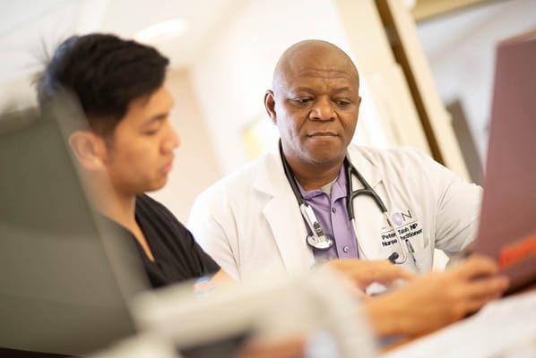 A doctor discussing with a nurse in a healthcare setting