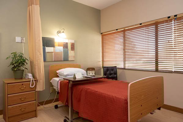 A well-furnished resident room with natural light