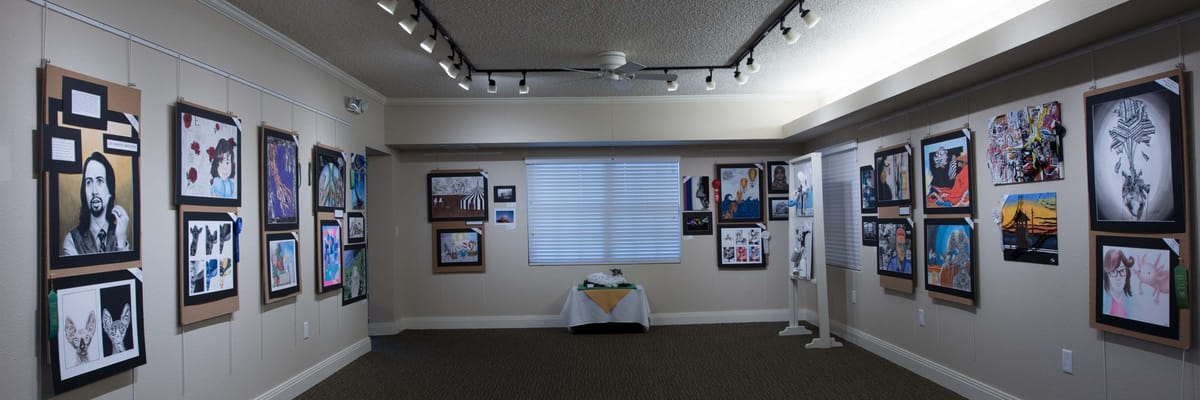 An interior art gallery with framed artworks on the walls