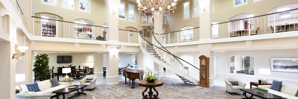 Bright common area with a grand staircase and seating