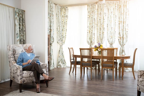 Resident reading in a bright interior space