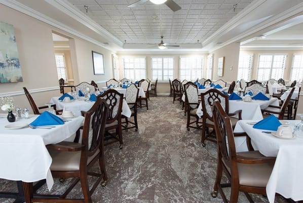 Bright dining room with tables set for meals