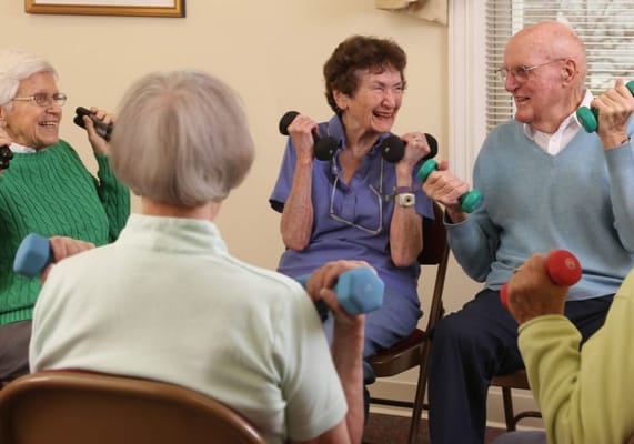 Residents participating in a light exercise class with weights