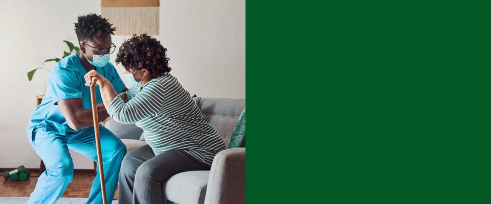 Caregiver assisting a resident in a comfortable living room