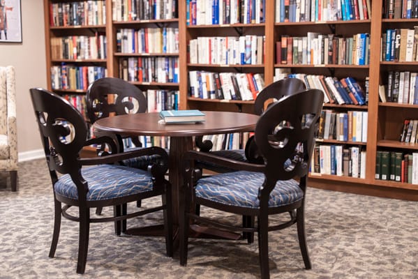 Cozy reading area with a round table and bookshelves
