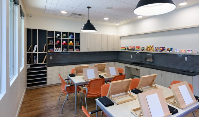 Art room set up for activities with easels and supplies