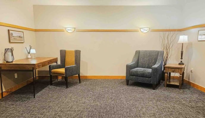 A cozy interior sitting area with chairs and a desk