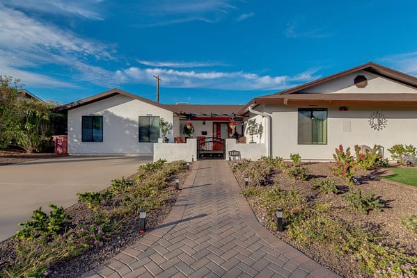 Exterior view of the facility with a pathway and garden