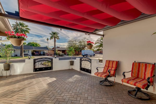 Outdoor seating area with colorful chairs and potted plants
