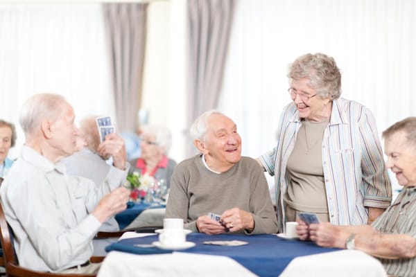 Residents playing cards in a communal activity area