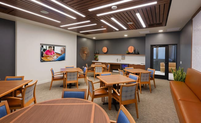 Common area with seating and a TV in a nursing home