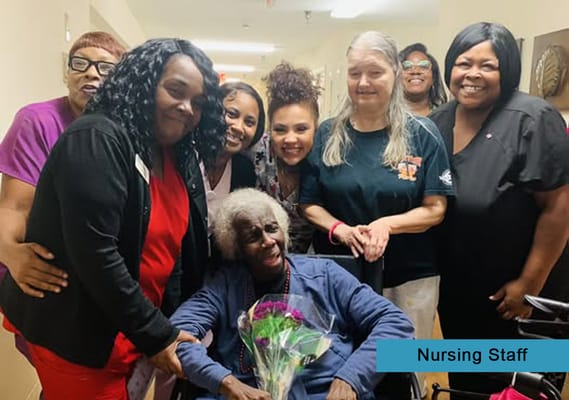 Nursing staff celebrating with a resident.