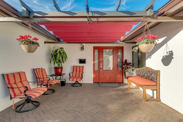 Quaint outdoor seating area with flowers and furniture