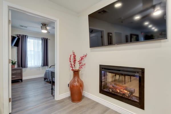 Interior view of a cozy resident room with a fireplace