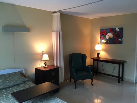 Private resident room with a bed and seating area