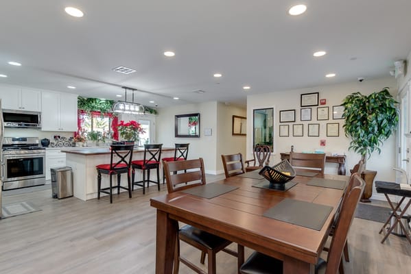 Bright common area with dining table and kitchen