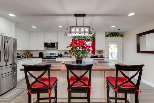 Modern kitchen with red accents and a holiday plant