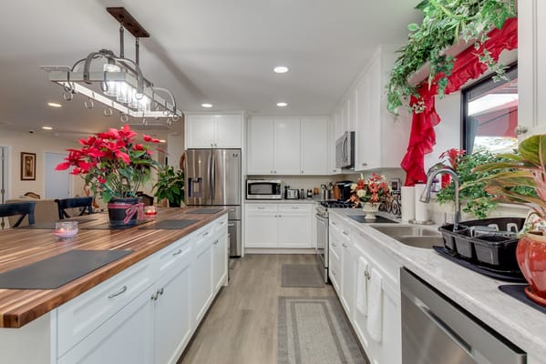 Bright kitchen with white cabinets and plants
