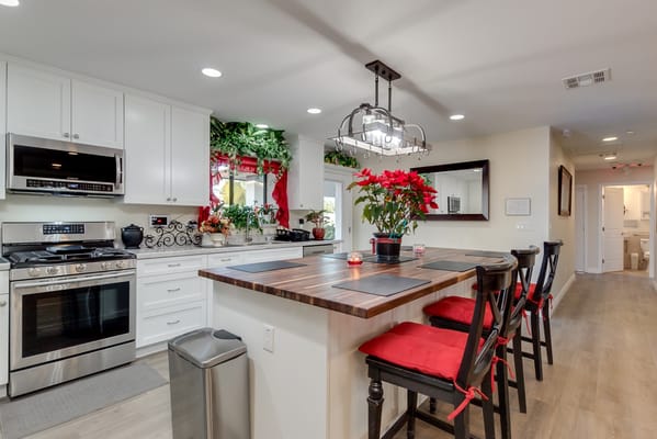 Modern kitchen with wood bar and red accents
